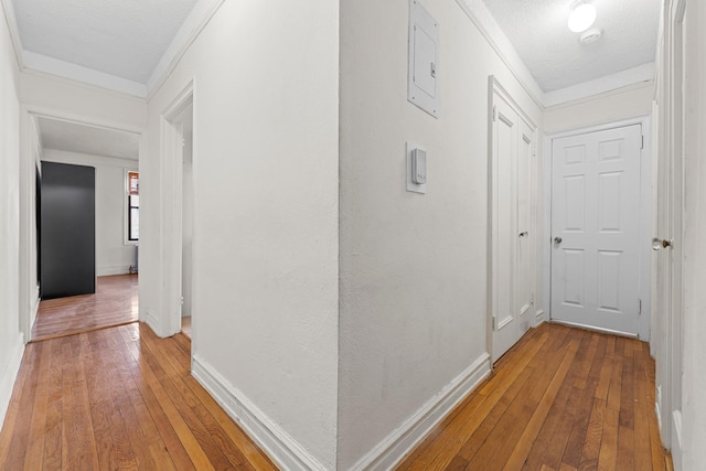 hall featuring hardwood / wood-style floors and a textured ceiling