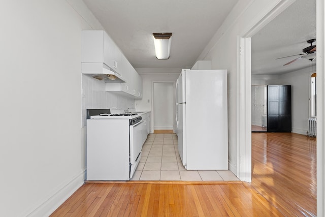 kitchen with premium range hood, radiator, white appliances, ceiling fan, and white cabinets