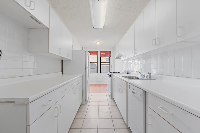 kitchen with white cabinets, white appliances, and sink