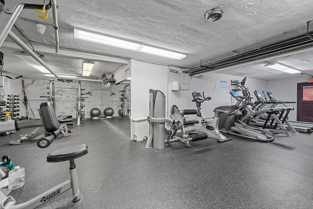 gym with a textured ceiling