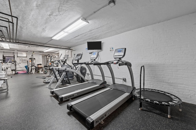 workout area with a textured ceiling