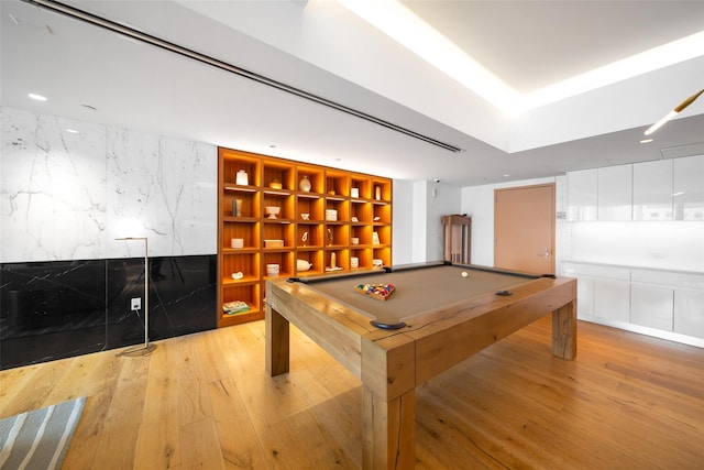 recreation room with pool table, built in features, and light hardwood / wood-style flooring