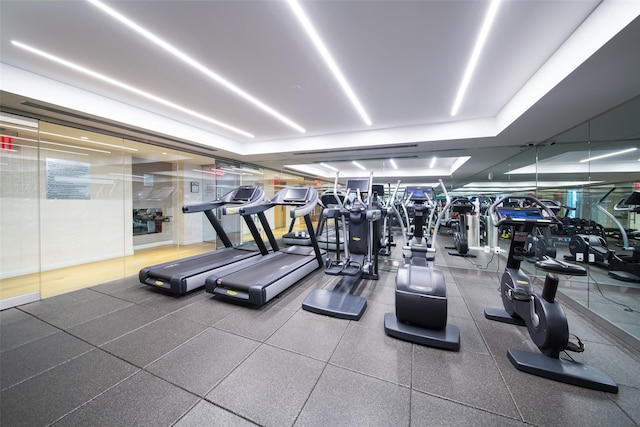 exercise room with a tray ceiling