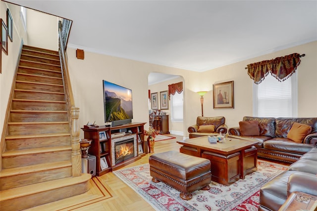 living room featuring crown molding and light parquet flooring