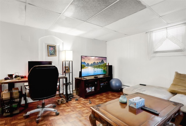 office space featuring parquet flooring and a drop ceiling