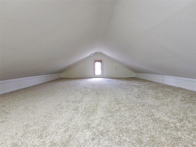 bonus room featuring carpet floors and vaulted ceiling