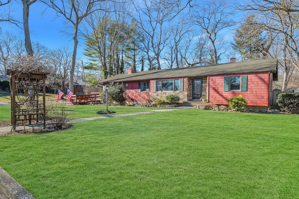 single story home with a playground and a front yard