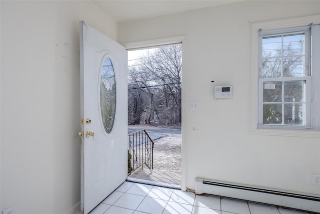 doorway to outside with baseboard heating and light tile patterned floors