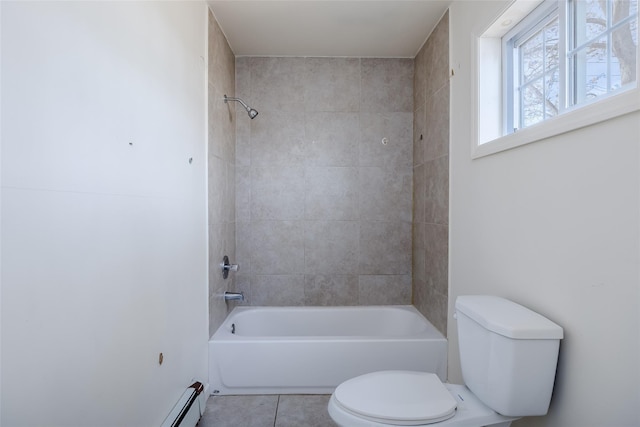 bathroom with toilet, tile patterned flooring, and tiled shower / bath