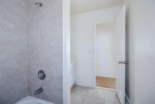 bathroom with tile patterned flooring and tiled shower / bath