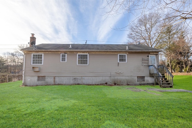 rear view of house with a yard