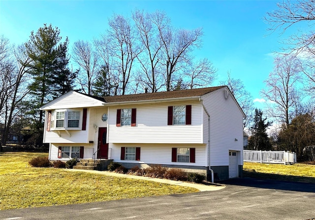 split foyer home with a front yard and a garage