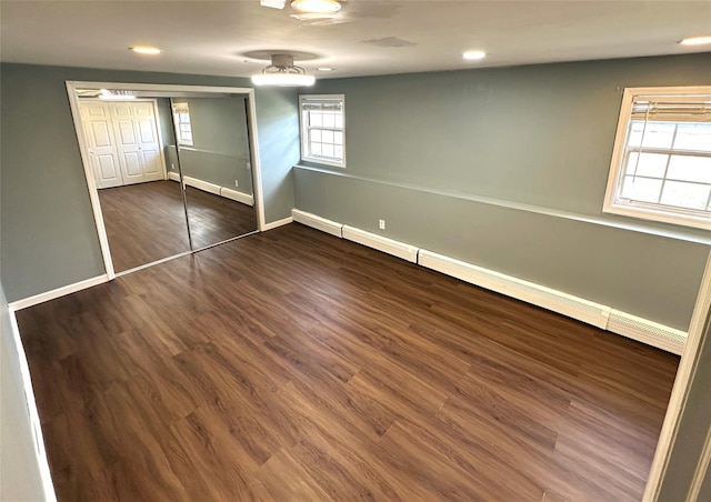 unfurnished bedroom with ceiling fan, a closet, and dark hardwood / wood-style floors