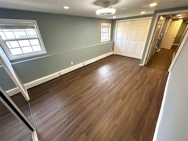 unfurnished bedroom with a closet and dark hardwood / wood-style flooring