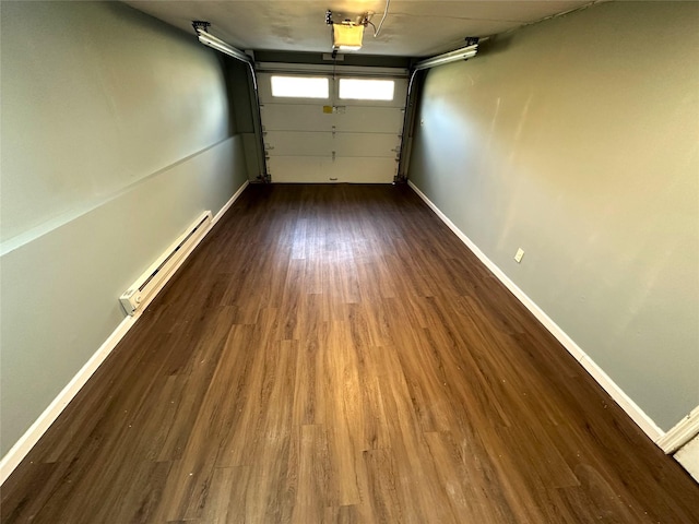 garage featuring a baseboard radiator and a garage door opener