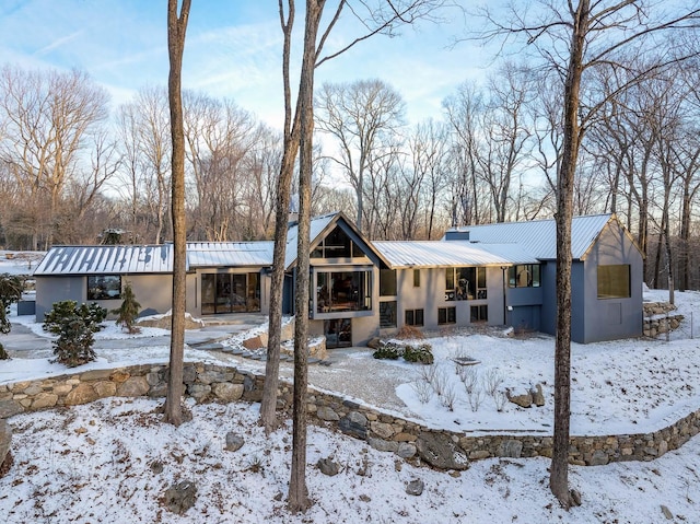 view of snow covered rear of property