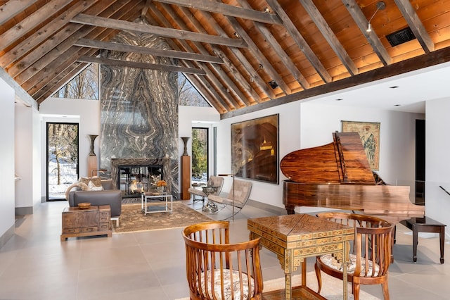 interior space featuring beam ceiling, wooden ceiling, high vaulted ceiling, and a high end fireplace