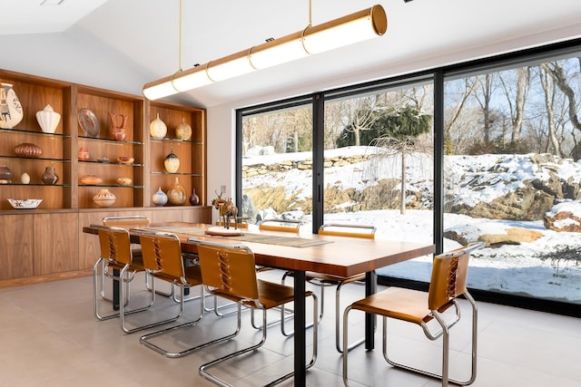 dining space with vaulted ceiling