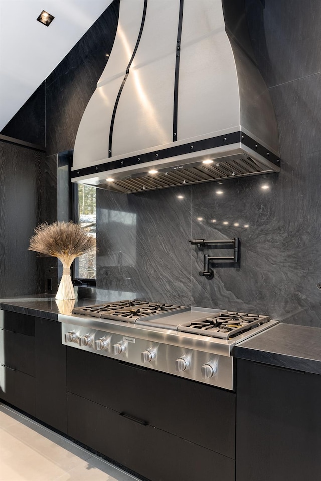 kitchen featuring tasteful backsplash, stainless steel gas stovetop, and island range hood