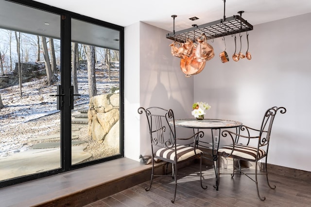 dining space featuring a wall of windows and hardwood / wood-style floors