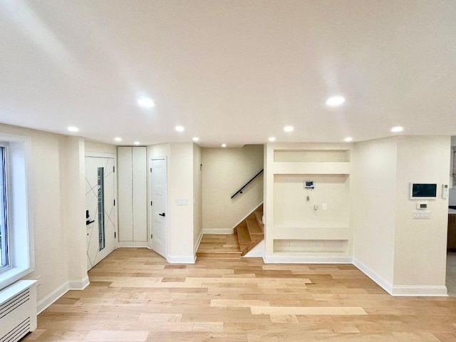 interior space with light hardwood / wood-style floors and radiator heating unit