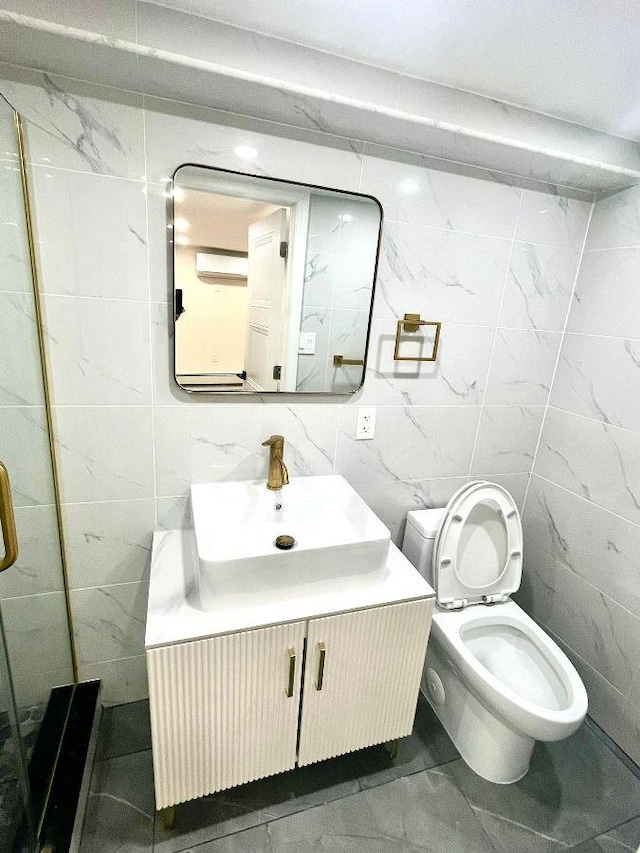 bathroom featuring tile walls, vanity, and toilet