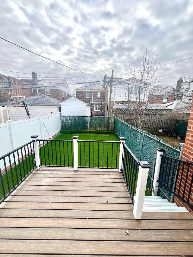 wooden terrace featuring a lawn