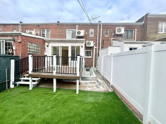 back of house with a yard and a wooden deck