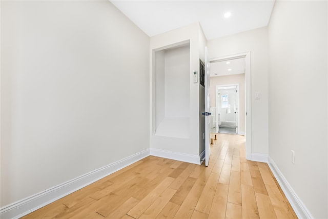 hall with wood-type flooring