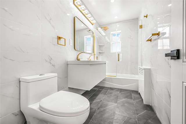 full bathroom featuring shower / bath combination, toilet, vanity, and tile walls