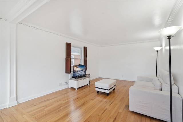 living room featuring wood-type flooring and crown molding