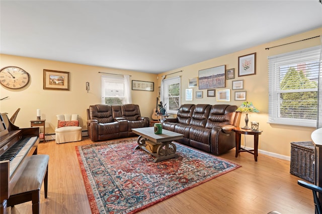 living room with light wood-type flooring and a baseboard radiator