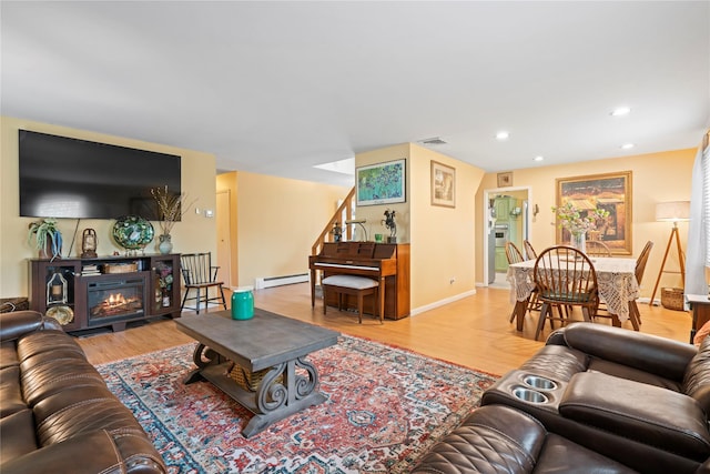 living room featuring baseboard heating and light wood-type flooring