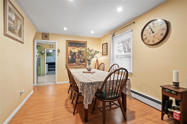 dining space featuring light hardwood / wood-style flooring and a baseboard heating unit