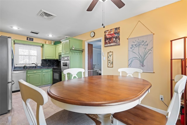 dining area featuring ceiling fan and sink