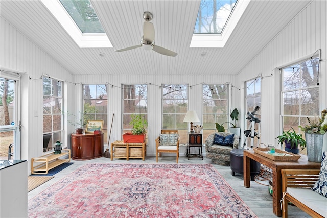 sunroom with ceiling fan and wooden ceiling