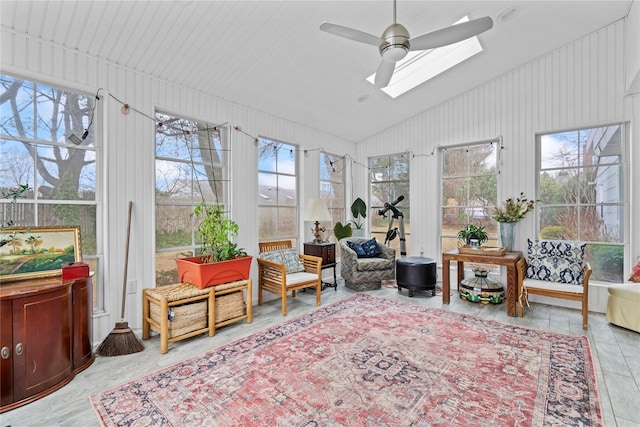 sunroom / solarium with ceiling fan and vaulted ceiling with skylight