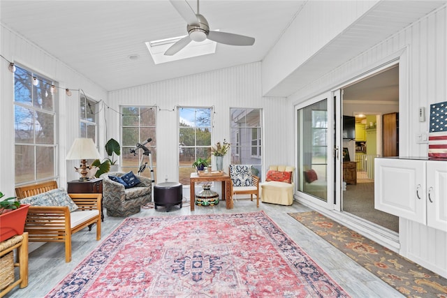 sunroom featuring ceiling fan and vaulted ceiling with skylight