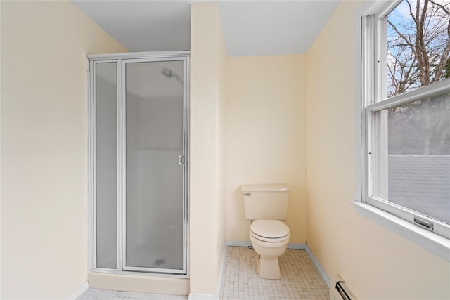 bathroom featuring toilet, an enclosed shower, and a baseboard radiator