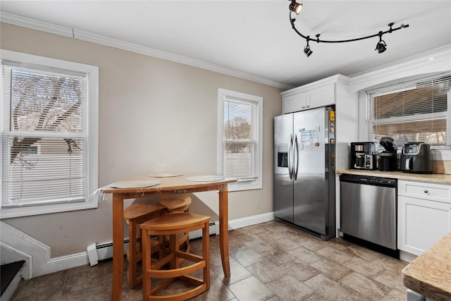 kitchen with white cabinetry, stainless steel appliances, track lighting, and ornamental molding