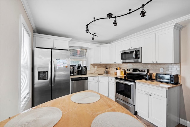 kitchen with white cabinets and appliances with stainless steel finishes