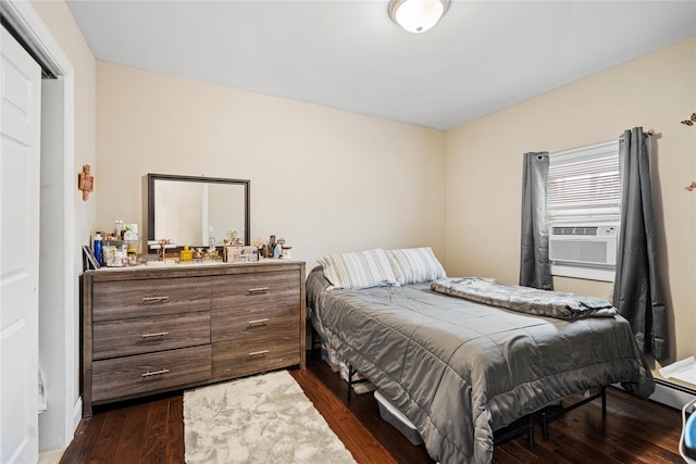 bedroom featuring dark hardwood / wood-style flooring and cooling unit