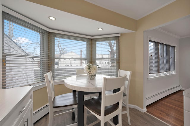 dining space featuring baseboard heating, dark hardwood / wood-style flooring, and ornamental molding