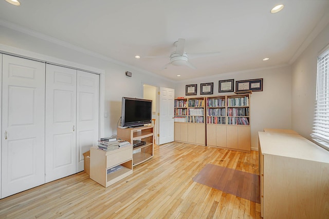 office space with ceiling fan, crown molding, and light wood-type flooring