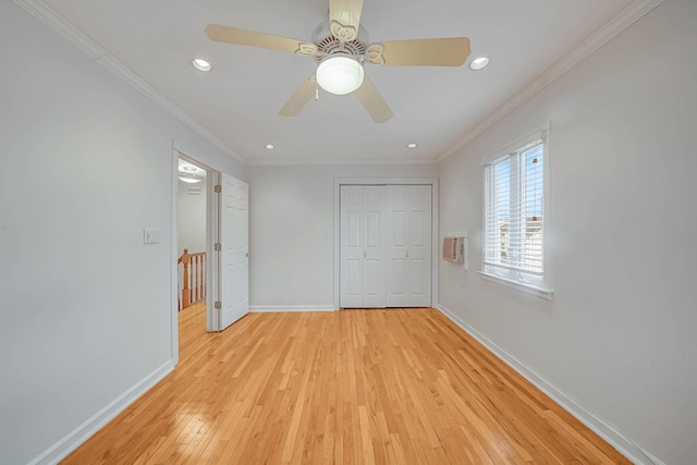 unfurnished bedroom with ceiling fan, light hardwood / wood-style floors, a closet, and crown molding