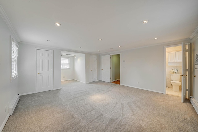 spare room with baseboard heating, light carpet, and crown molding