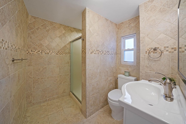 bathroom with toilet, vanity, tile walls, and an enclosed shower