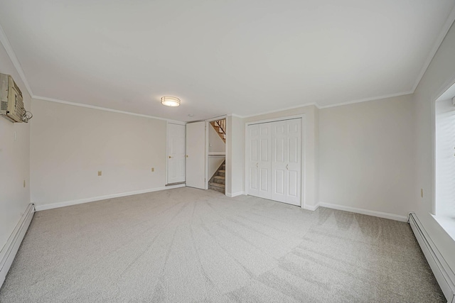 carpeted spare room featuring baseboard heating and ornamental molding