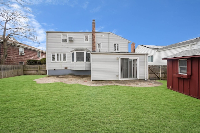 back of house featuring a lawn and a patio