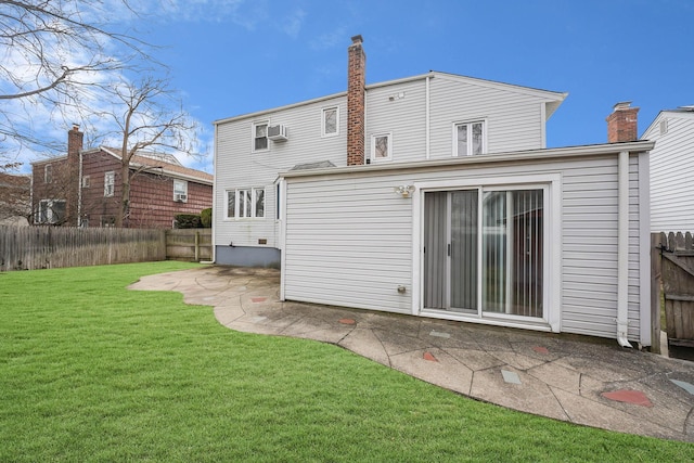 back of property with a patio area and a yard